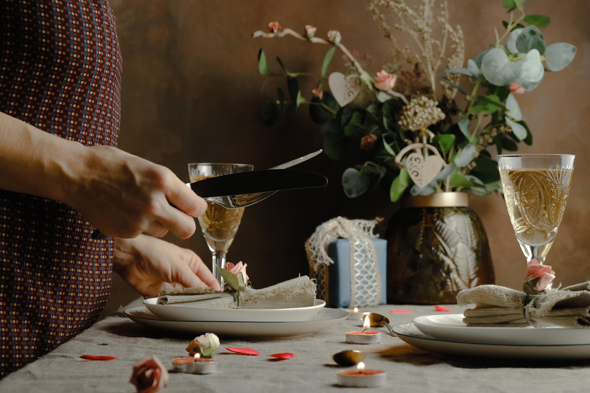Intimate dining table set with candles and porcelain